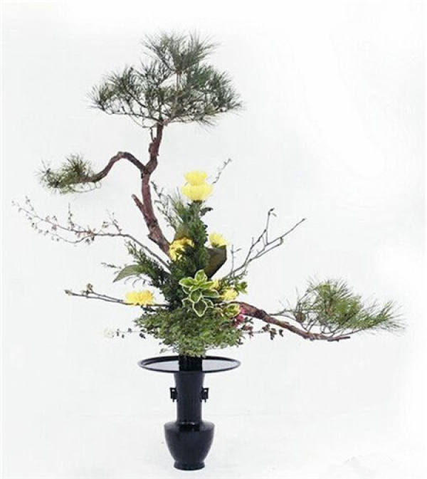 Oriental style flower arrangement features four: 